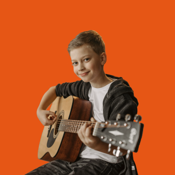 teenage boy playing guitar